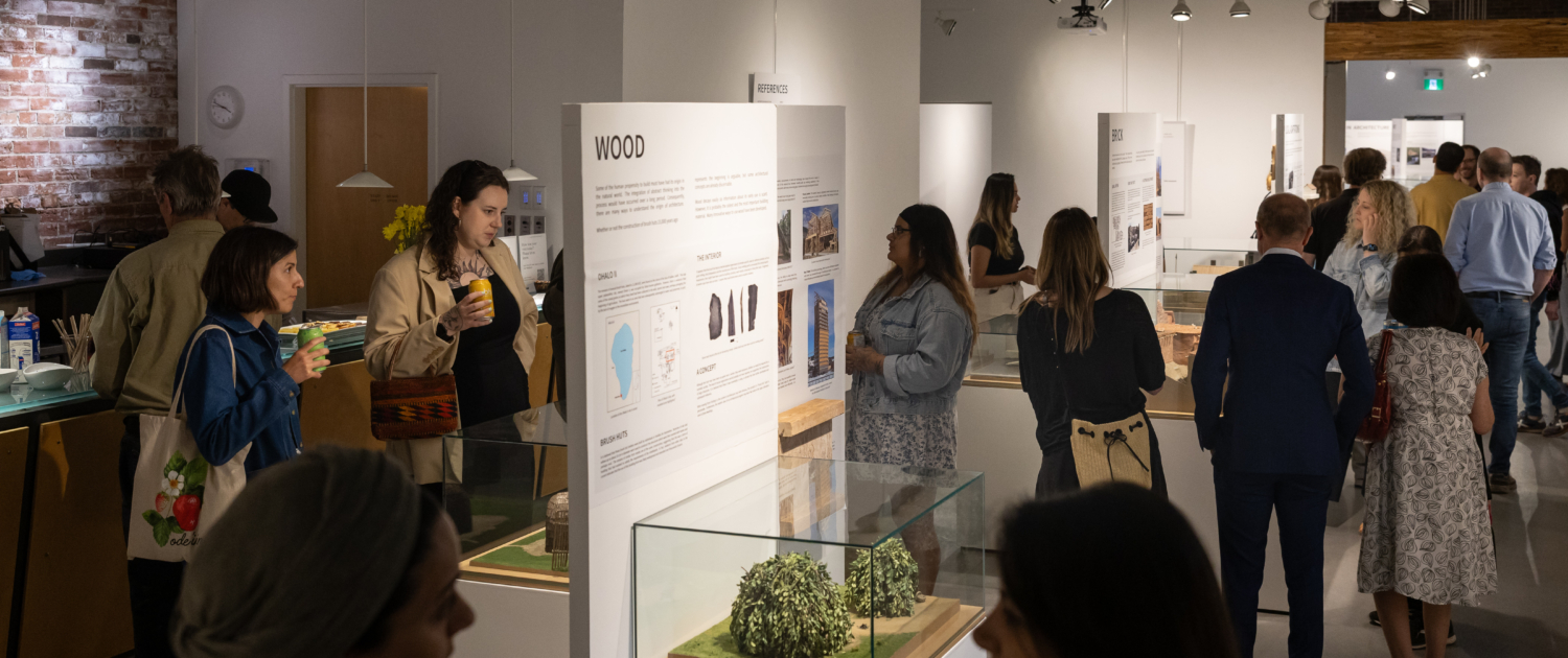 20250820-154834-THM-TodmordenMills-CanadianMuseumOfArchitecture-AndrewWilliamson-7303 A long view of the exhibition with many visitors attending.